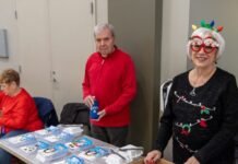 children receiving Christmas toys at community event