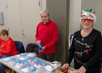 children receiving Christmas toys at community event