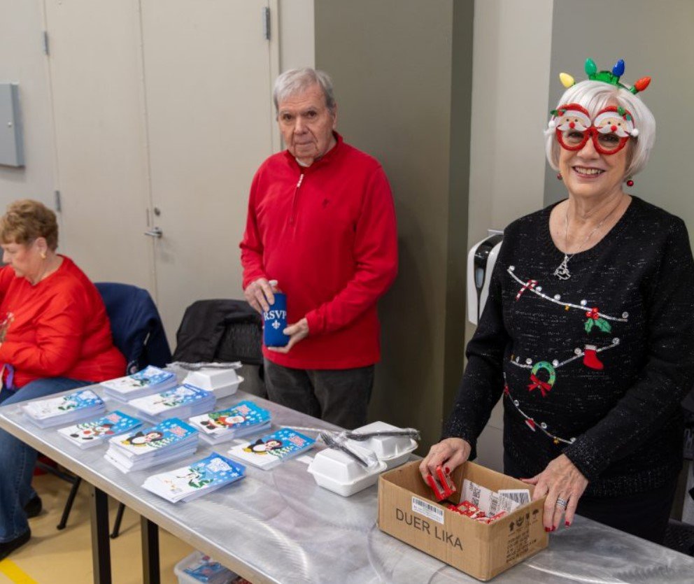 children receiving Christmas toys at community event